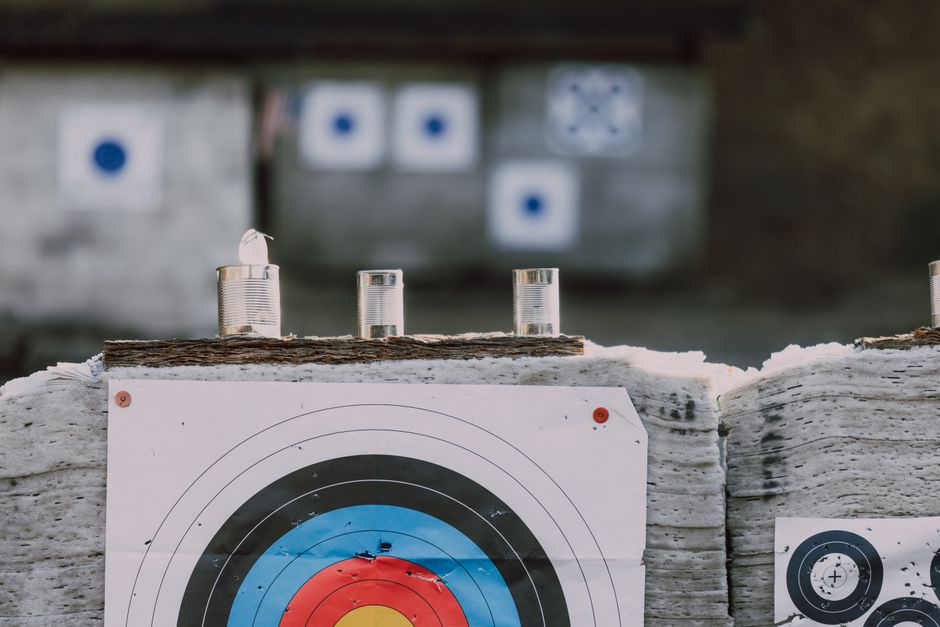 Competitive shooting sports event with targets and trained marksmen in action